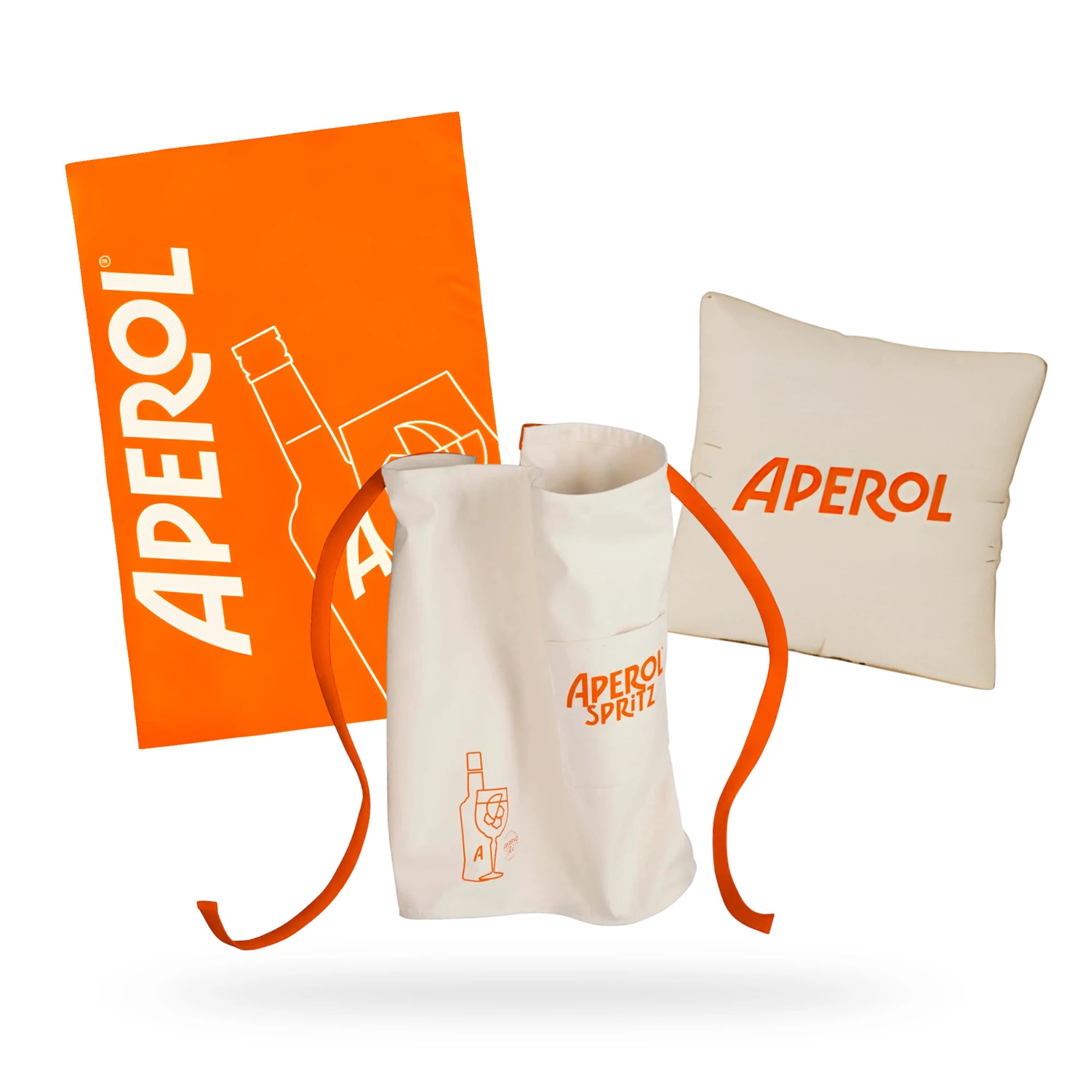 Aperol-branded home bundle with orange towel, white apron, and beige cushion for cozy lounging