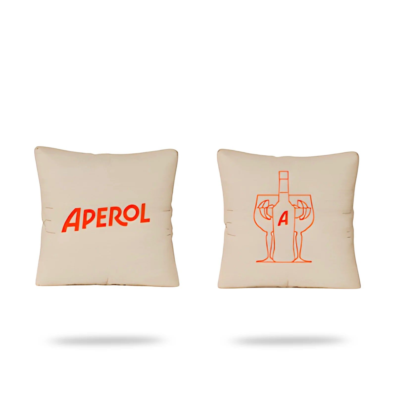 Set of two beige Aperol cushions, one with red logo and one with minimalist bottle and glass illustration