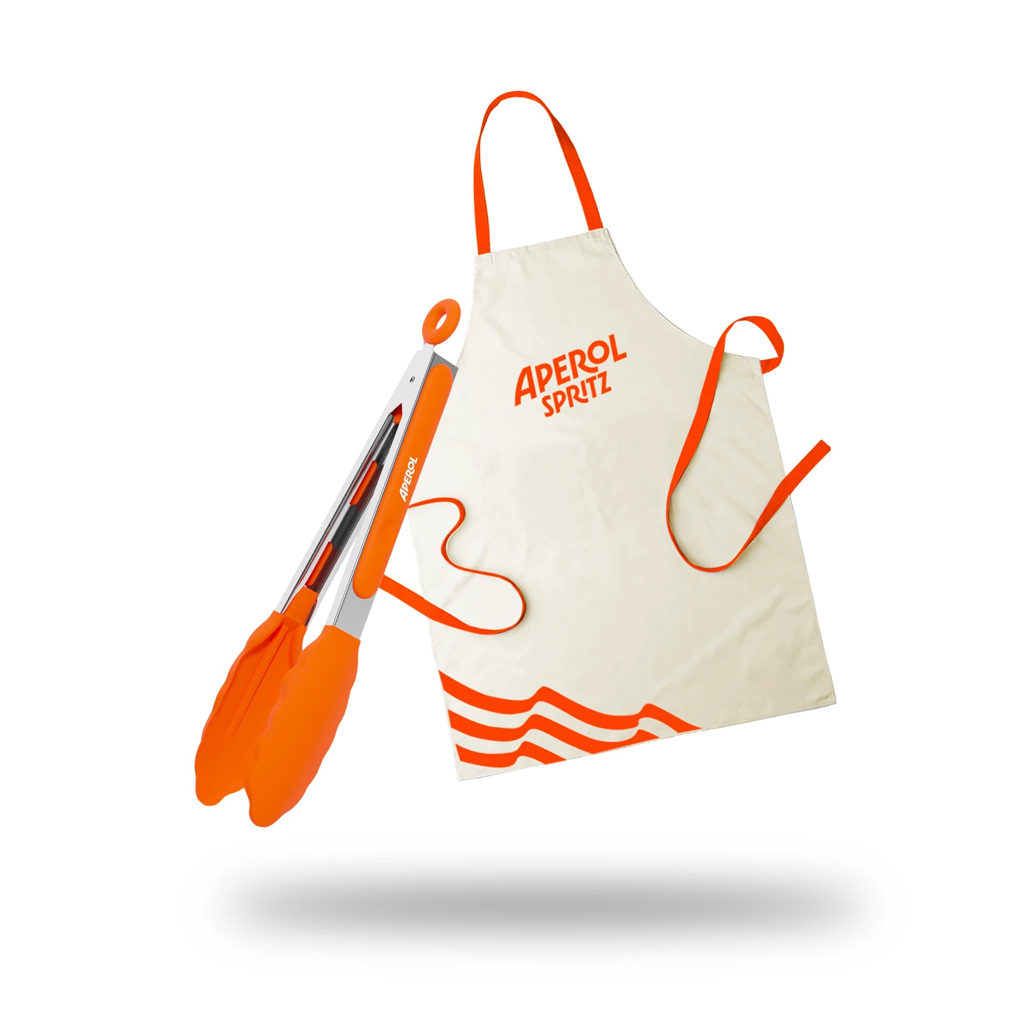 Aperol-branded BBQ bundle featuring an off-white apron with orange straps and logo, alongside a pair of stainless steel tongs with orange silicone tips, displayed against a white background with a soft shadow.