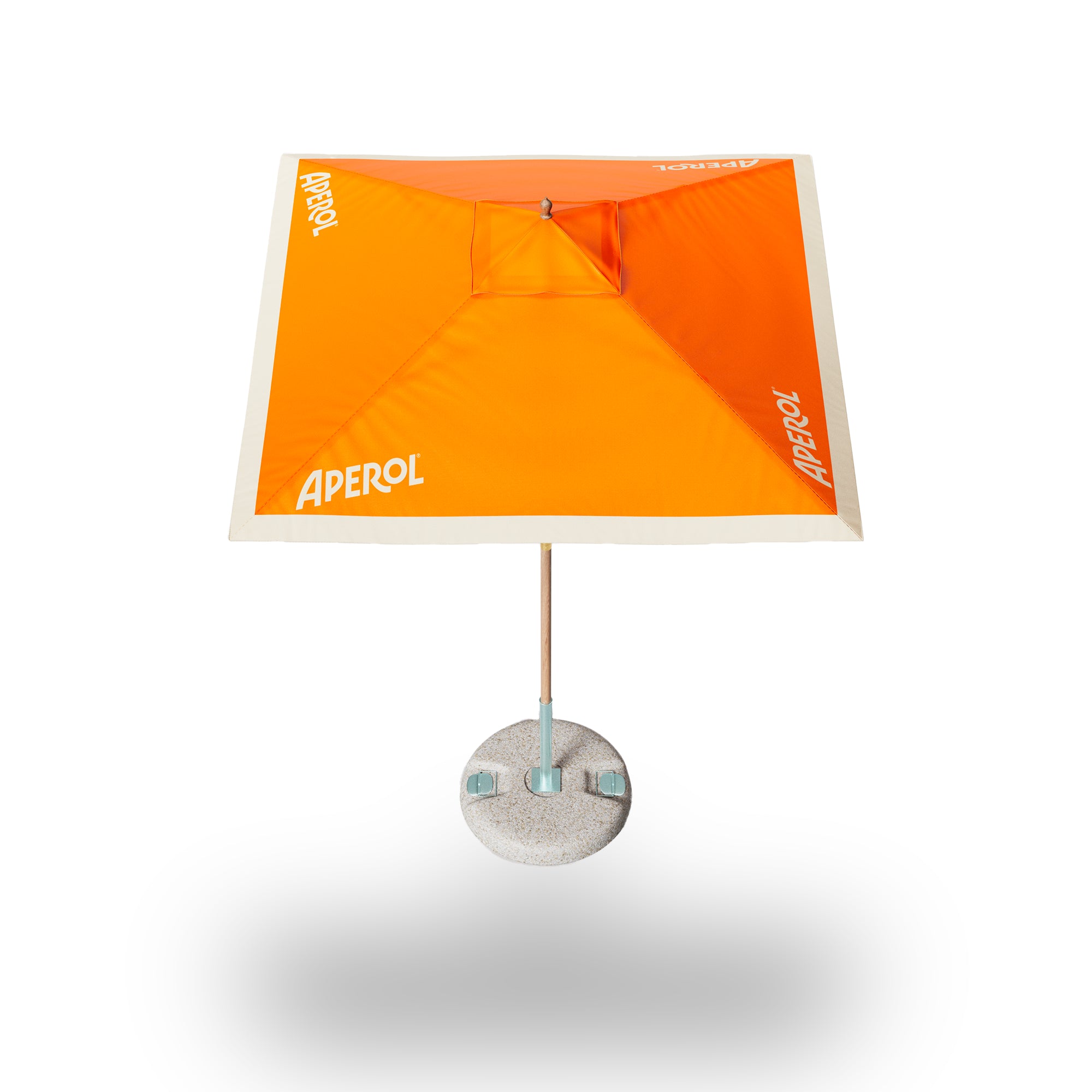 Square Aperol patio umbrella with orange canopy, cream border, and concrete base, viewed from above
