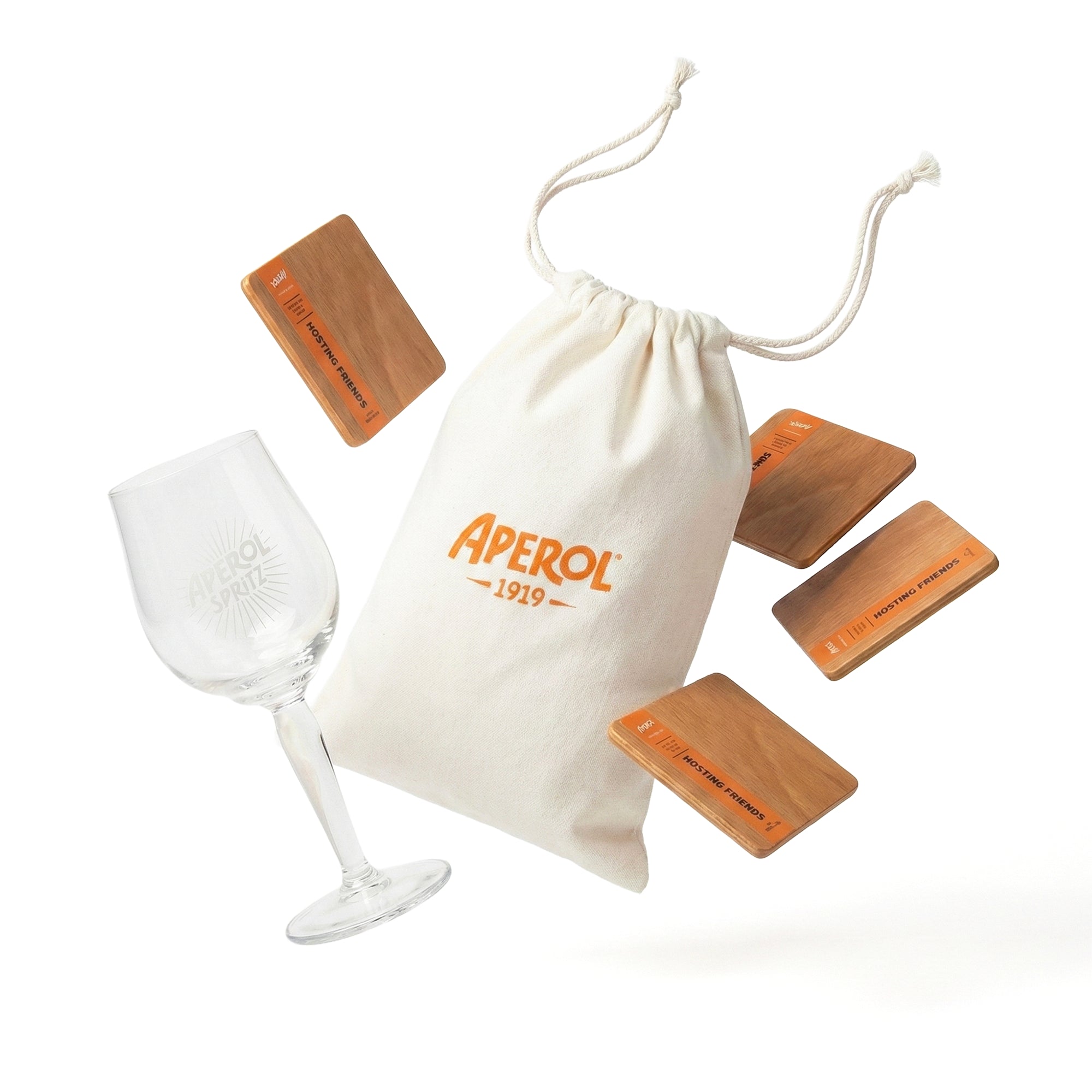 Wine glass, wooden blocks, and Aperol branded drawstring bag on a white background
