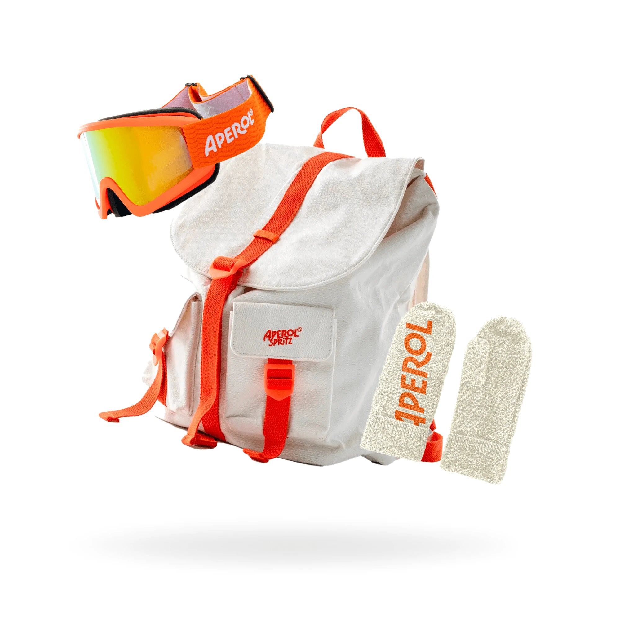 Aperol-branded winter travel set including an off-white backpack with orange straps, matching cream mittens with orange branding, and orange ski goggles with reflective lenses, displayed on a white background.