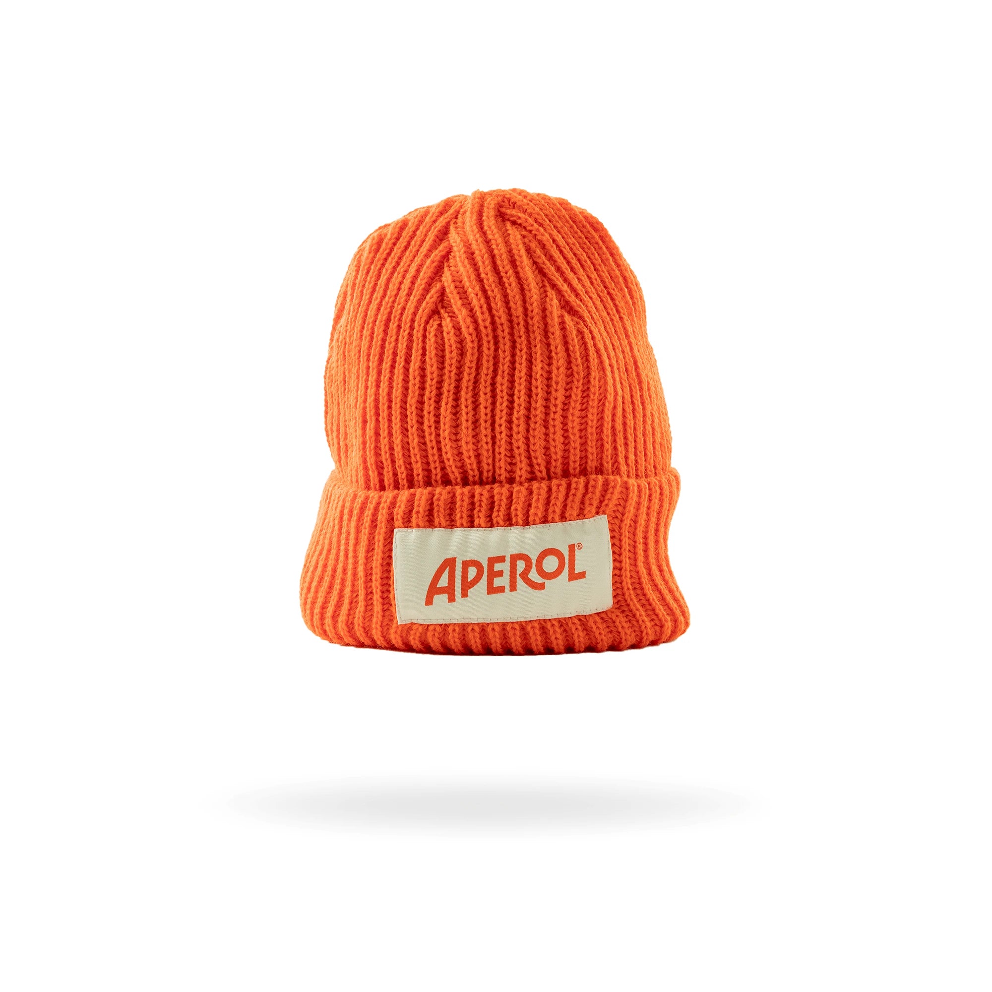 Bright orange ribbed knit beanie with a folded brim, featuring a white patch embroidered with the Aperol logo in red, displayed on a white background.