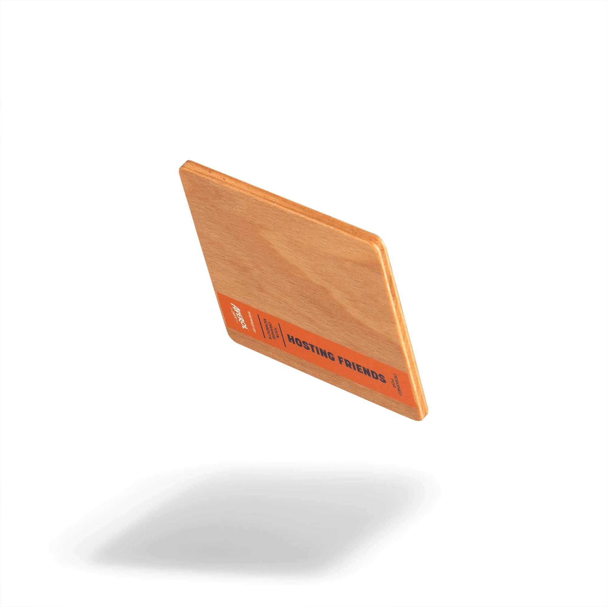 Wooden coaster with orange 'Hosting Friends' label, shown from an angled side view, floating with a soft shadow on white background.