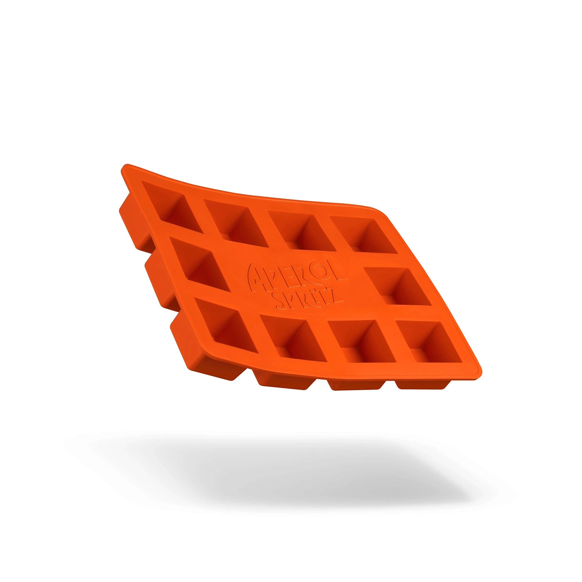 Bright orange silicone ice cube tray with the Aperol Spritz logo, floating against a white background with a soft shadow underneath.