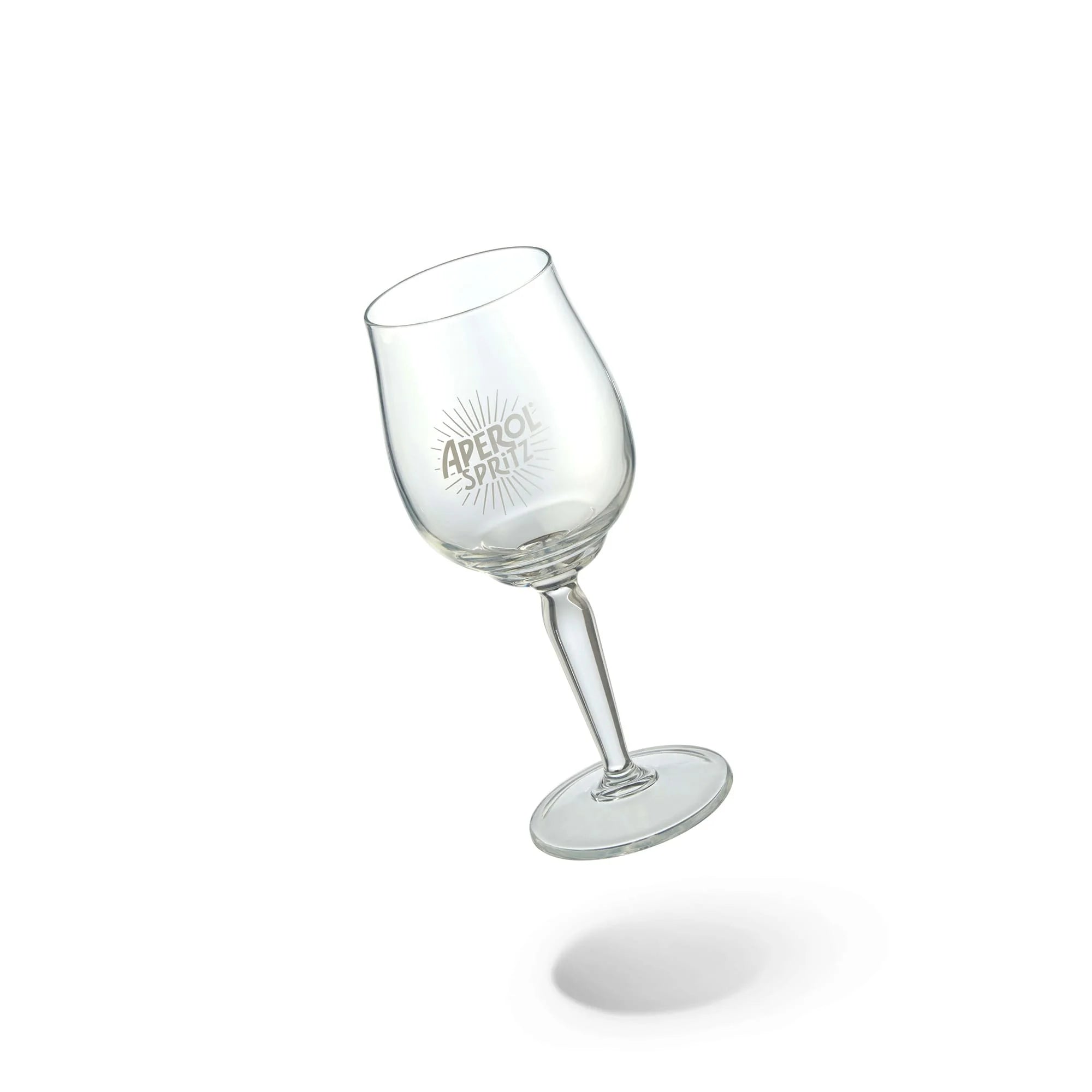 Clear Aperol Spritz signature wine glass with sunburst logo, tilted on white background
